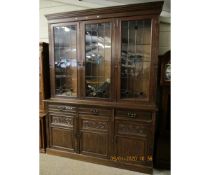 LATE 19TH CENTURY OAK BOOKCASE WITH THREE LEADED AND GLAZED DOORS, THE BASE FITTED WITH THREE