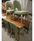 MODERN EXTENDING DINING TABLE TOGETHER WITH FOUR GREEN UPHOLSTERED HORSESHOE BACKED DINING CHAIRS
