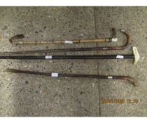 THREE MIXED WALKING STICKS AND A FURTHER RIDING CROP