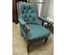 19TH CENTURY MAHOGANY FRAMED ARMCHAIR WITH GREEN UPHOLSTERY AND BUTTON BACK AND REEDED LEGS RAISED