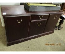 TEAK EFFECT SIDEBOARD FITTED CENTRALLY WITH A SINGLE DRAWER OVER A CUPBOARD DOOR FLANKED EITHER SIDE