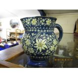 THUNE POTTERY JUG, THE BLUE GROUND DECORATED IN WHITE WITH FLORAL SPRAYS, 12CM HIGH
