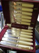 RED LEATHER CASED SET OF BONE HANDLED FISH KNIVES AND FORKS