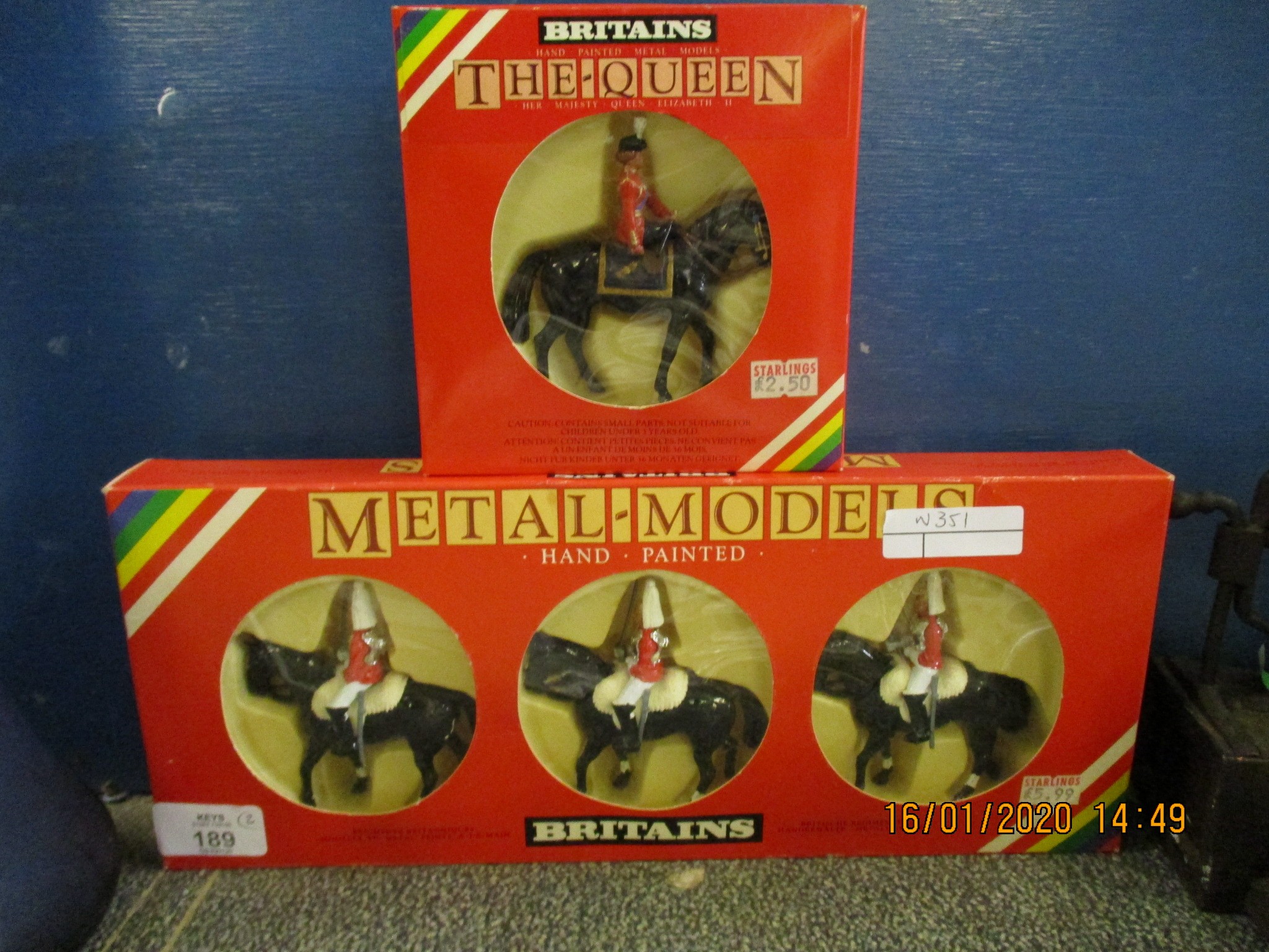 BOXED BRITAIN’S “THE QUEEN” FIGURE AND FURTHER THREE HORSE MOUNTED GUARDS