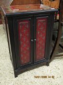 GOOD QUALITY PAINTED CUPBOARD WITH TWO DOORS WITH RED AND EBONISED FLORAL PAINTED DESIGN