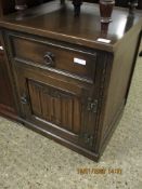 OLD CHARM OAK BEDSIDE CUPBOARD WITH SINGLE DRAWER OVER LINENFOLD CUPBOARD DOOR