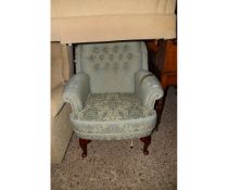 GREEN UPHOLSTERED FLORAL FIRESIDE CHAIR ON STAINED BEECHWOOD LEGS