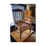 OAK FRAMED ARMCHAIR WITH RED UPHOLSTERED ARMS AND TOP RAIL