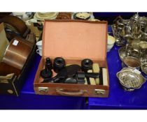LEATHER CASED CONTAINING A QUANTITY OF EBONY DRESSING TABLE WARES TO INCLUDE HAIR TIDIES, BRUSHES