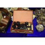 LEATHER CASED CONTAINING A QUANTITY OF EBONY DRESSING TABLE WARES TO INCLUDE HAIR TIDIES, BRUSHES