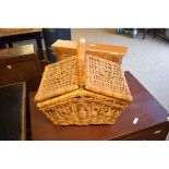 WICKER HAMPER WITH A QUANTITY OF TREEN BOWLS, PLATES ETC