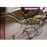 Vintage dog cart containing the remnants of original cane and fabric upholstery over a wrought