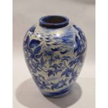 Pottery baluster vase painted in blue with a floral design, 28cm high