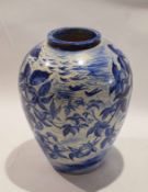 Pottery baluster vase painted in blue with a floral design, 28cm high