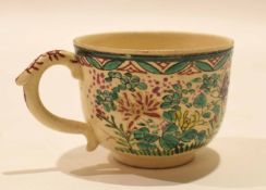 Pottery cup decorated in a famille vert palette