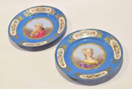 Two French porcelain Sevres style plates decorated with a gentleman and a lady within a scrolling