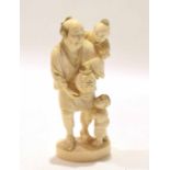 Japanese ivory figure of a man with two children, Meiji period, with one child on his back and