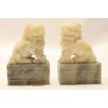 Pair of soapstone carvings of dragons or dogs of fo on quartz bases, 10cm high (2)