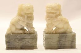 Pair of soapstone carvings of dragons or dogs of fo on quartz bases, 10cm high (2)