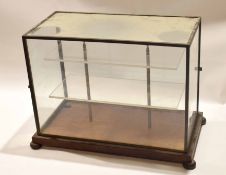 Vintage metal and glass display case on four bun feet, 50cm wide