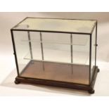 Vintage metal and glass display case on four bun feet, 50cm wide