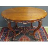 Mahogany oval centre table with rosette moulded frieze raised on four swept supports, joined by an