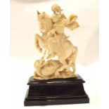 Late 19th century ivory carving of St George and the Dragon on a wooden rectangular base, 17cm high