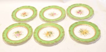 Group of Coalport plates with floral designs, late 19th/early 20th century, with retailer's stamp