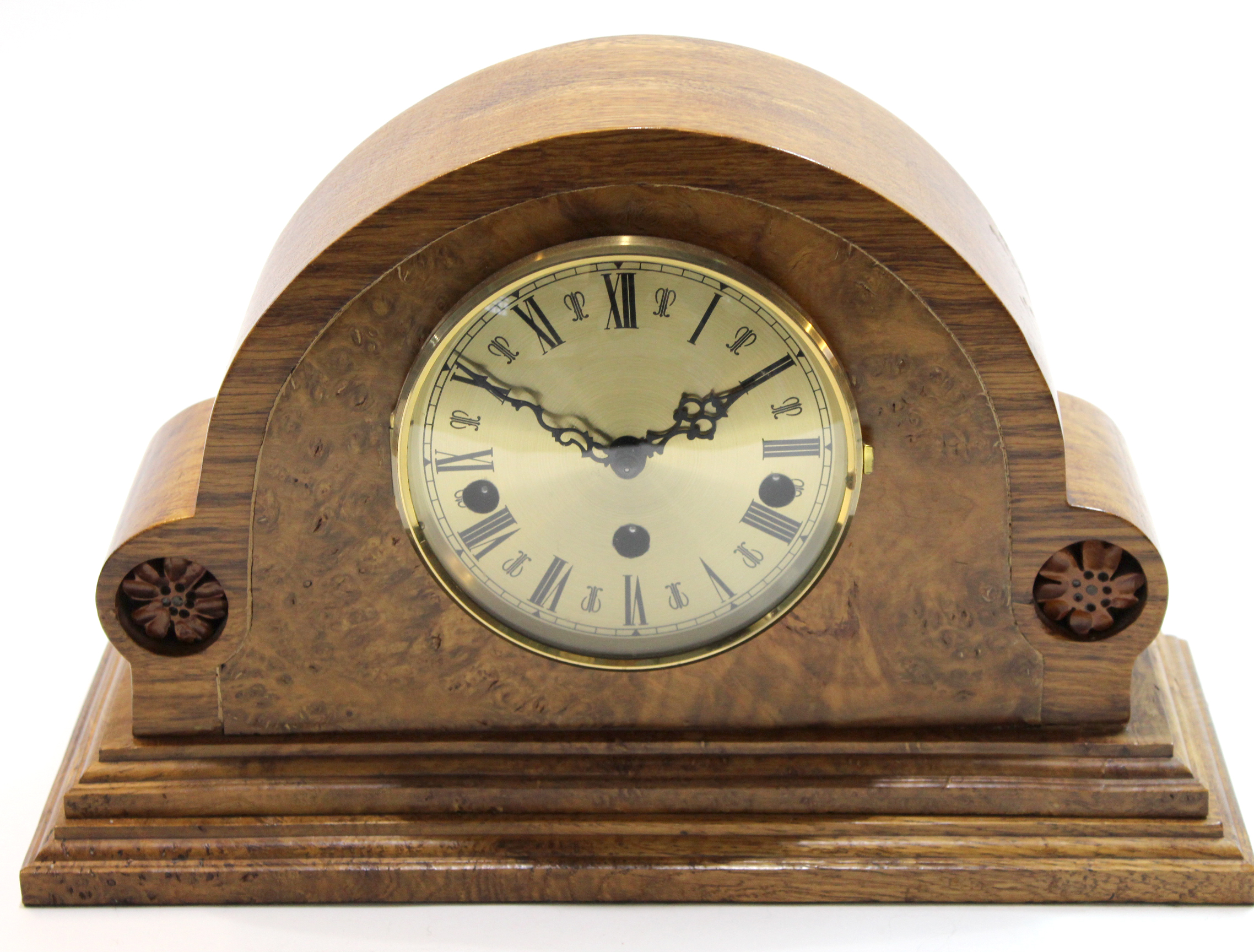 Modern mantel clock in shaped figured walnut case, 33cm long