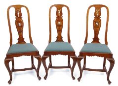 Set of six early 20th century walnut dining chairs, the arched tops with vase shaped splat backs,