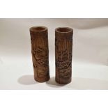 Pair of bamboo carved brush holders, carved with figures in various pursuits, 35cm high (2)