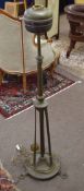 Brass adjustable standard lamp (converted to electricity) raised on pointed feet in the Arts &