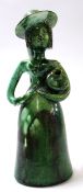 Unusual pottery sculpture of a woman with jar under her arm, green glazed with monogram JJ to
