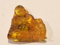 Oriental composition amber coloured figure, 5cm high