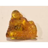 Oriental composition amber coloured figure, 5cm high