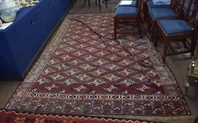 Early 20th century Yomut carpet decorated with the Dyrnak Guls design, the central panel with