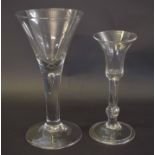 18th century wine glass with bell shaped bowl above a baluster stem, together with a further large