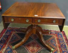 Mahogany drop flap pedestal table of rectangular form, the frieze fitted on either side with drawers