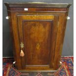 Late 18th century oak wall mounting corner cabinet, panelled door enclosing fitted shelving, 79cm