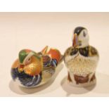 Two Royal Crown Derby paperweights with silver tops, one modelled as a duck, the other as a
