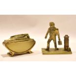 Ronson brass table lighter and further brass model of a workman, 9cm and 10cm long respectively (2)