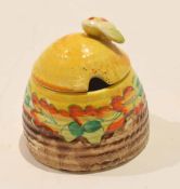 Clarice Cliff beehive jam pot and cover with a floral design and Bizarre factory mark to base