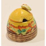 Clarice Cliff beehive jam pot and cover with a floral design and Bizarre factory mark to base