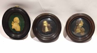 Framed set of three circular wax or composition silhouette type busts in oval and circular frames