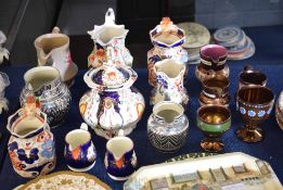 Group of 19th century pottery and porcelain jugs and a tea pot, two decorated with Imari designs,