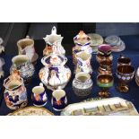 Group of 19th century pottery and porcelain jugs and a tea pot, two decorated with Imari designs,