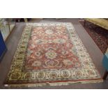 Indian or Chinese modern carpet, triple gull border, central panel of stylised foliage on a rust