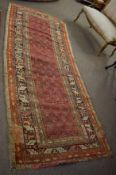 Caucasian wool runner, multi gull border, central panel of geometric designs on a red ground