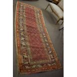 Caucasian wool runner, multi gull border, central panel of geometric designs on a red ground