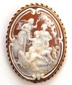 Antique oval carved shell cameo brooch depicting a Bacchanalian group scene in a yellow metal frame,